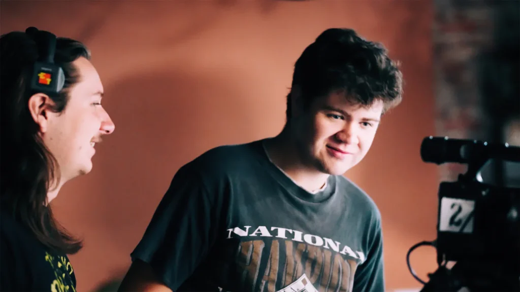 tow men looking at a camera